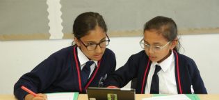 Children working and using a tablet